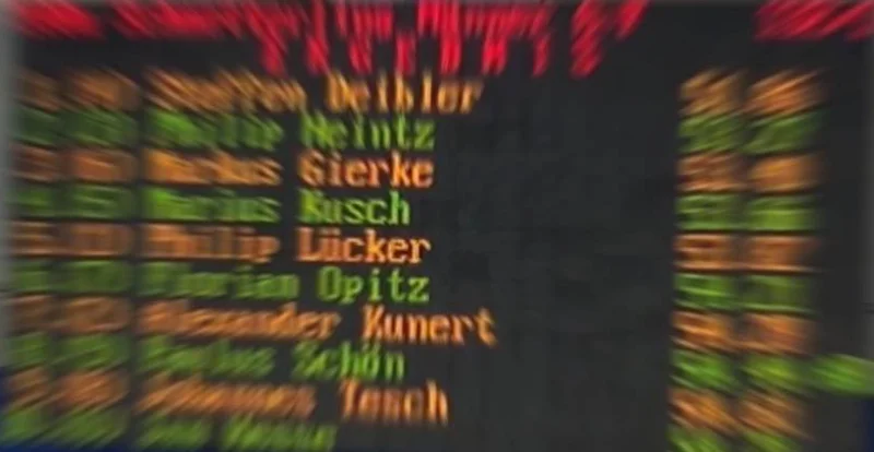 An old amber results board with athlete names and times